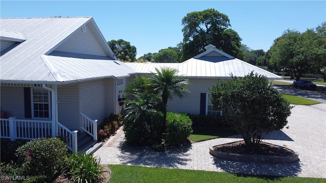 234 W Circle Dr, Clewiston, FL 33440 - view of property exterior with covered porch and metal roof