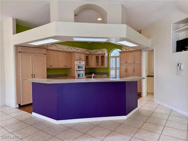 234 W Circle Dr, Clewiston, FL 33440 - kitchen featuring light tile patterned floors, baseboards, a spacious island, glass insert cabinets, and white double oven