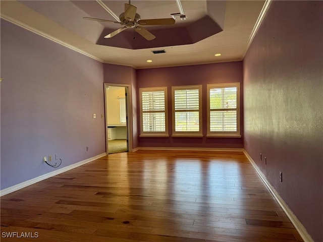 234 W Circle Dr, Clewiston, FL 33440 - empty room with visible vents, ornamental molding, a ceiling fan, wood-type flooring, and a raised ceiling