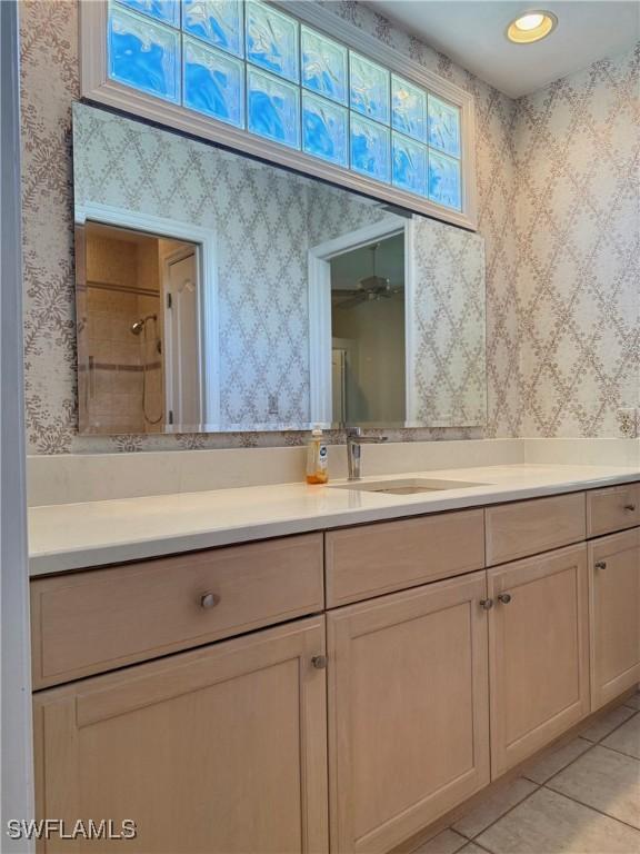 234 W Circle Dr, Clewiston, FL 33440 - full bathroom featuring tiled shower, vanity, tile patterned flooring, and wallpapered walls