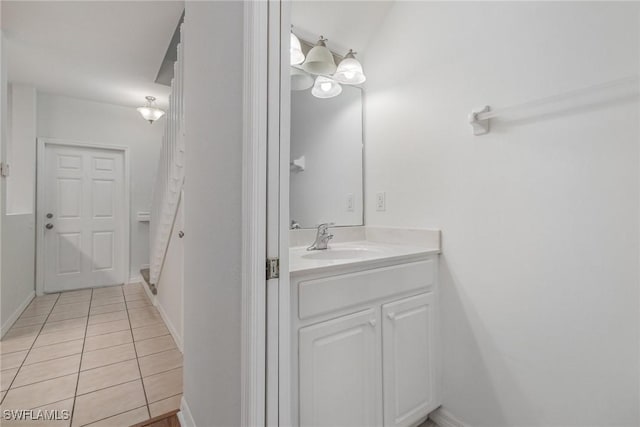 bathroom with tile patterned floors, vanity, and baseboards