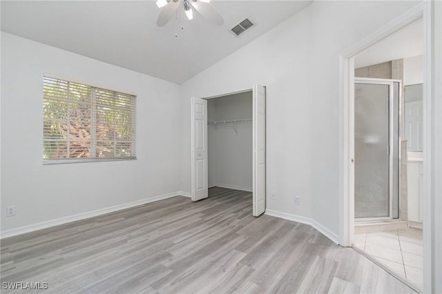 unfurnished bedroom featuring visible vents, light wood finished floors, baseboards, ceiling fan, and vaulted ceiling