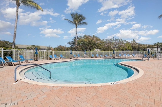 pool featuring fence and a patio area