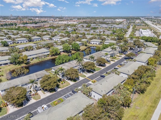 birds eye view of property with a residential view and a water view
