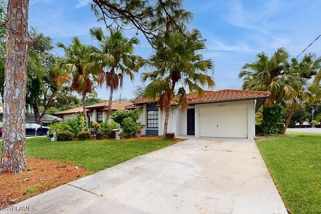 single story home featuring stucco siding, driveway, a front yard, a tile roof, and a garage