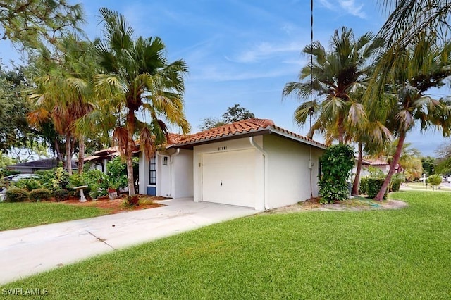 view of side of home featuring a yard, a garage, a tile roof, stucco siding, and driveway