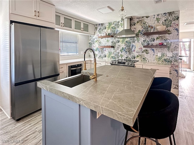 27881 Meadowlark Ln, Bonita Springs, FL 34134 - kitchen with freestanding refrigerator, wall chimney exhaust hood, open shelves, range, and a textured ceiling