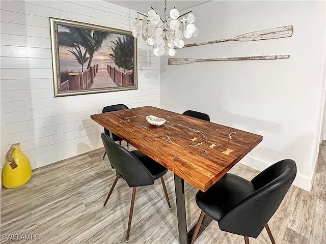 27881 Meadowlark Ln, Bonita Springs, FL 34134 - dining space featuring a chandelier, wood finished floors, and wood walls