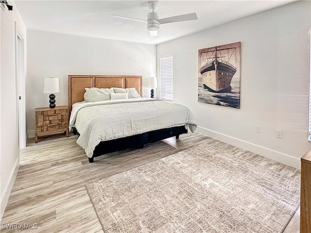 27881 Meadowlark Ln, Bonita Springs, FL 34134 - bedroom with light wood finished floors and ceiling fan