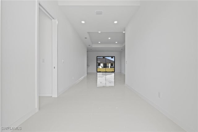 3808 10th St SW, Lehigh Acres, FL 33976 - hall featuring a raised ceiling, recessed lighting, baseboards, and tile patterned floors