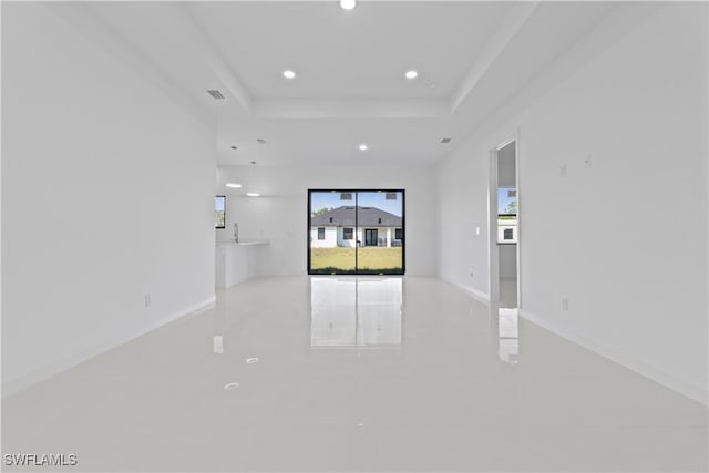 3808 10th St SW, Lehigh Acres, FL 33976 - empty room featuring visible vents, baseboards, a tray ceiling, recessed lighting, and a sink