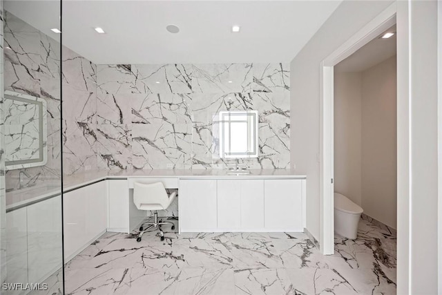 1165 8th St S Unit 202, Naples, FL 34102 - full bathroom featuring marble finish floor, stone wall, toilet, and vanity