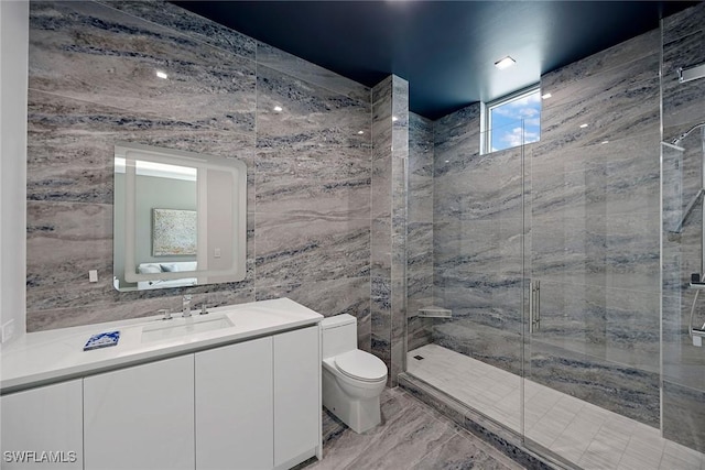 1165 8th St S Unit 202, Naples, FL 34102 - bathroom featuring toilet, vanity, a stall shower, and tile walls