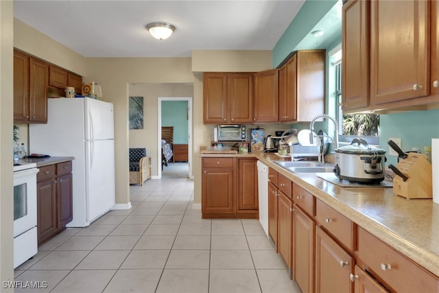 4764 Pembrooke Ln, Bonita Springs, FL 34134 - kitchen with light countertops, white appliances, a sink, light tile patterned flooring, and brown cabinets
