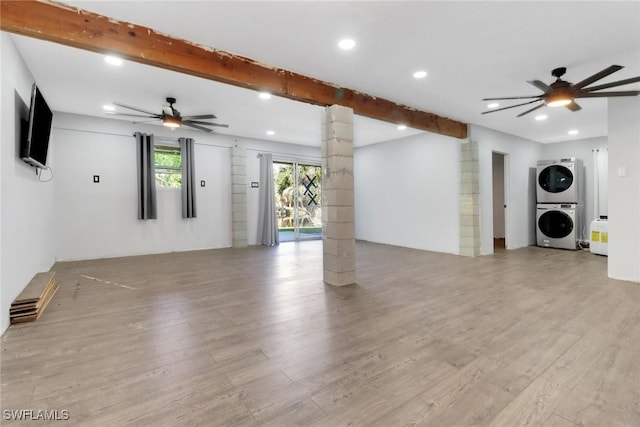 4764 Pembrooke Ln, Bonita Springs, FL 34134 - interior space featuring decorative columns, stacked washer and clothes dryer, ceiling fan, and light wood-style floors