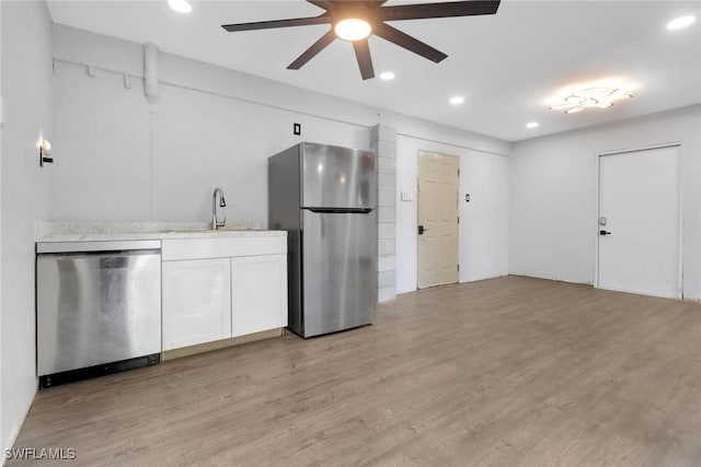 4764 Pembrooke Ln, Bonita Springs, FL 34134 - kitchen with a sink, light wood-type flooring, stainless steel appliances, white cabinets, and ceiling fan