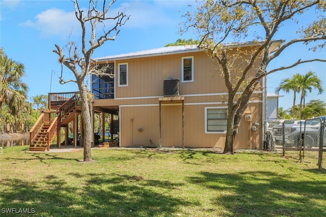 4764 Pembrooke Ln, Bonita Springs, FL 34134 - back of property featuring a lawn, stairs, fence, and a wooden deck
