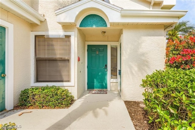 doorway to property with stucco siding