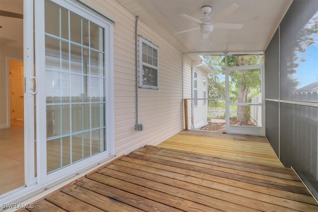 unfurnished sunroom featuring ceiling fan