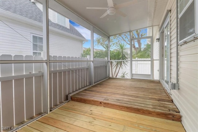 unfurnished sunroom featuring plenty of natural light and ceiling fan
