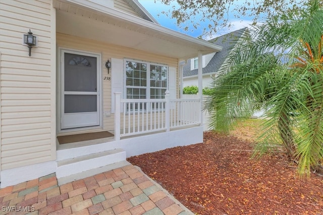 view of exterior entry with covered porch
