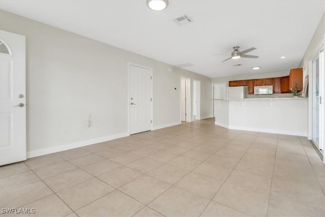 unfurnished living room featuring visible vents, a ceiling fan, recessed lighting, light tile patterned floors, and baseboards