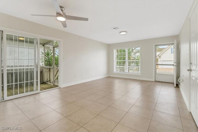 unfurnished room featuring light tile patterned floors, baseboards, visible vents, and ceiling fan