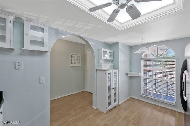 529 Mardel Dr Unit 311, Naples, FL 34104 - foyer entrance featuring ceiling fan, arched walkways, wood finished floors, and baseboards