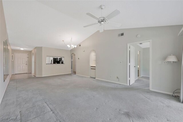 529 Mardel Dr Unit 311, Naples, FL 34104 - unfurnished living room featuring a ceiling fan, carpet flooring, vaulted ceiling, baseboards, and arched walkways