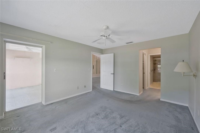529 Mardel Dr Unit 311, Naples, FL 34104 - unfurnished bedroom with baseboards, a textured ceiling, carpet floors, ensuite bathroom, and ceiling fan