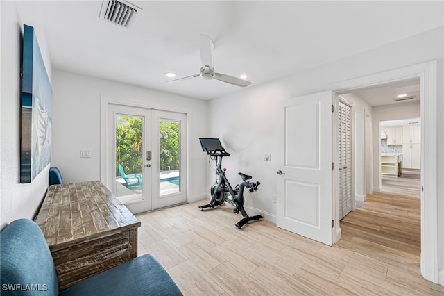 workout room featuring visible vents, french doors, light wood finished floors, baseboards, and ceiling fan