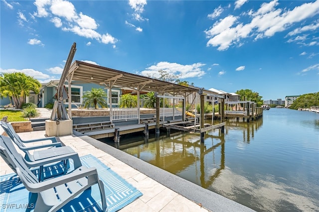 dock area with a water view and boat lift