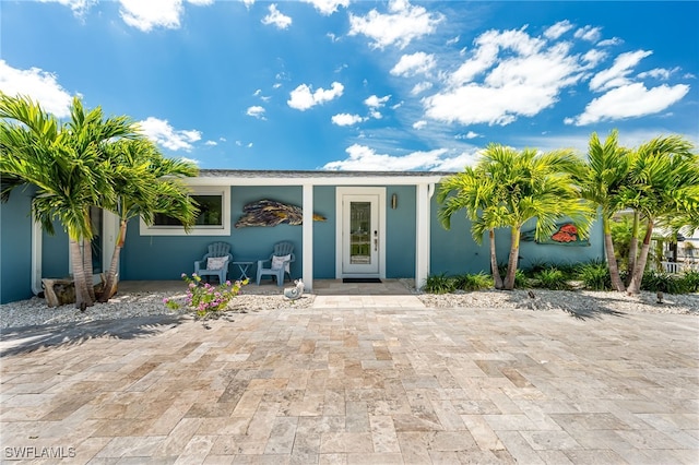 property entrance with stucco siding
