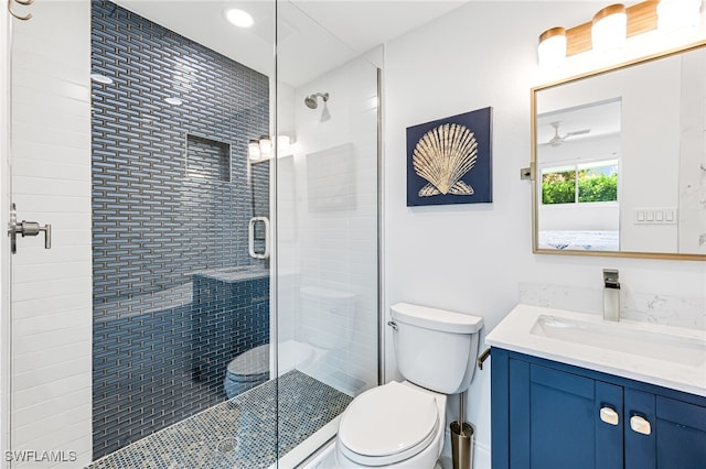 full bathroom with vanity, toilet, and a shower stall