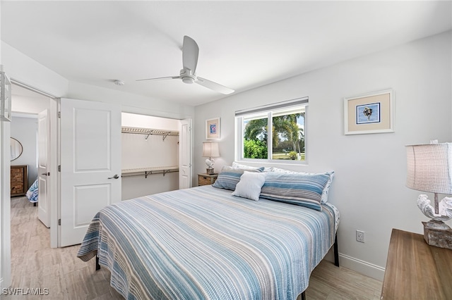 bedroom with light wood-type flooring, a closet, baseboards, and a ceiling fan
