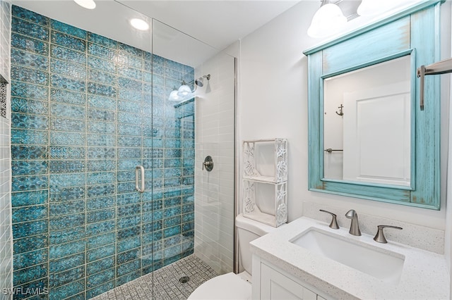 bathroom featuring vanity, toilet, and a stall shower