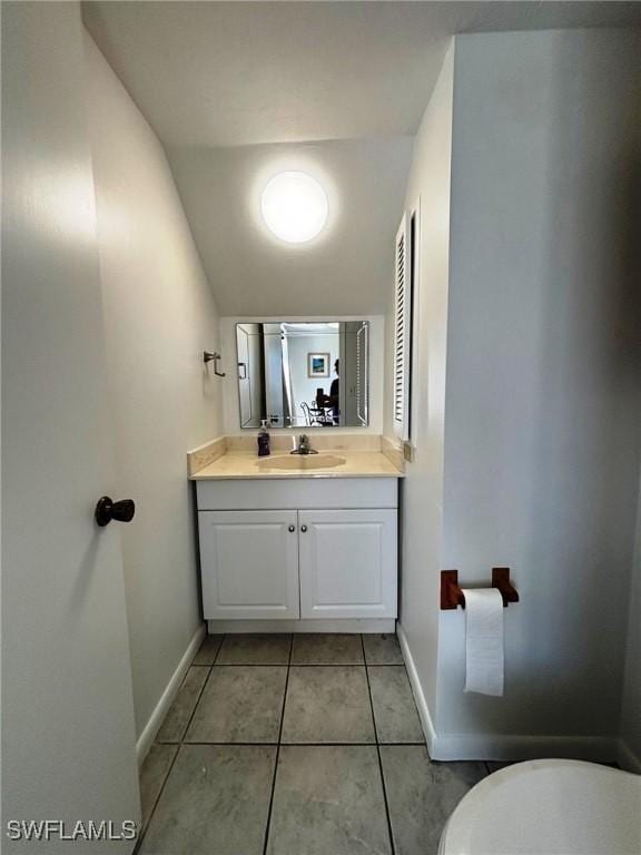 4903 Vincennes St Unit 116, Cape Coral, FL 33904 - half bath with toilet, vanity, tile patterned floors, and baseboards