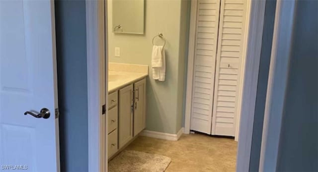 bathroom featuring baseboards and vanity