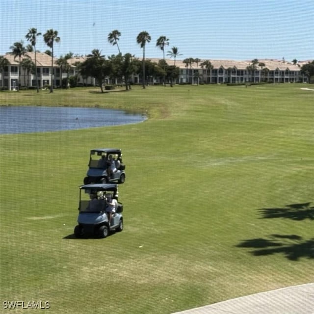 surrounding community with a yard and a water view