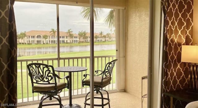 sunroom with a wealth of natural light and a water view