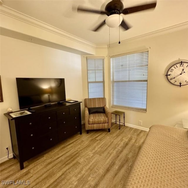 living area with wood finished floors, ceiling fan, and ornamental molding
