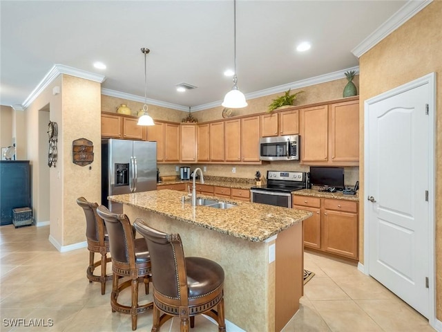 20240 Black Tree Ln, Estero, FL 33928 - kitchen with an island with sink, a sink, stainless steel appliances, crown molding, and light stone countertops