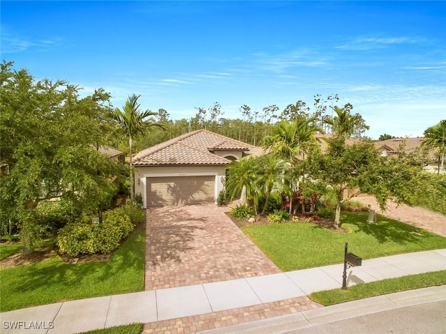 20240 Black Tree Ln, Estero, FL 33928 - mediterranean / spanish home with a front yard, stucco siding, a garage, a tile roof, and decorative driveway