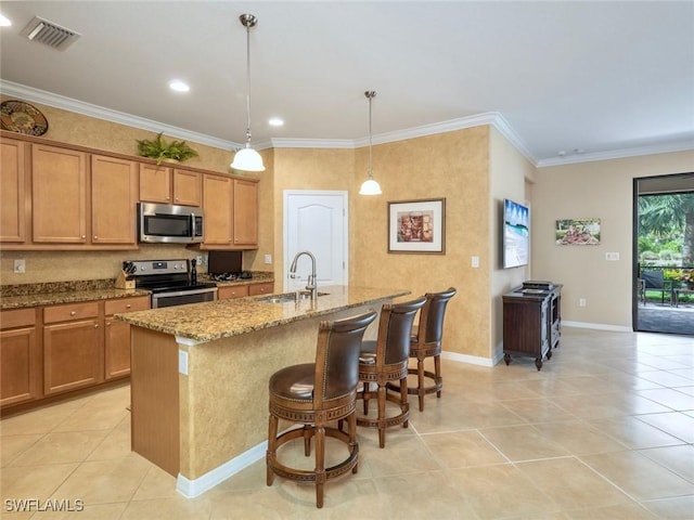 20240 Black Tree Ln, Estero, FL 33928 - kitchen featuring visible vents, a center island with sink, a sink, stainless steel appliances, and light stone countertops
