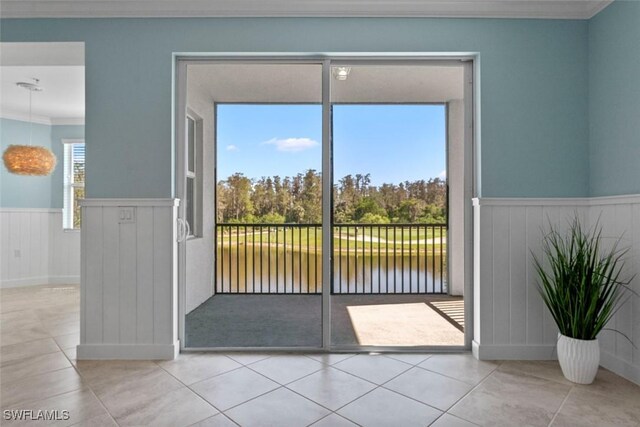 6058 National Blvd Unit 327, Ave Maria, FL 34142 - doorway featuring a water view, ornamental molding, wainscoting, and tile patterned flooring