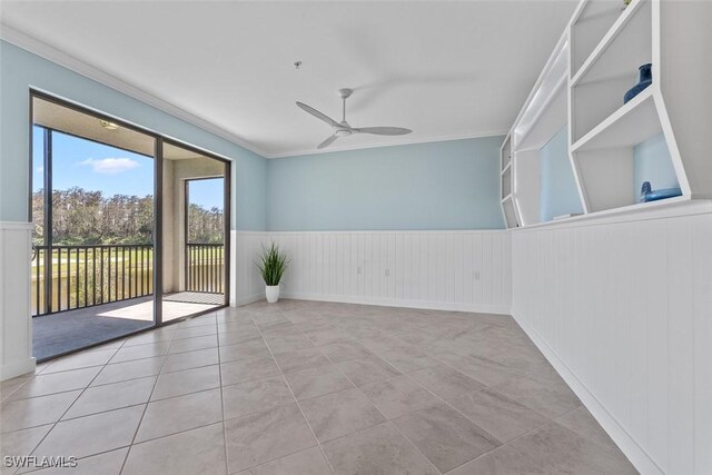 6058 National Blvd Unit 327, Ave Maria, FL 34142 - tiled empty room featuring a ceiling fan, wainscoting, and ornamental molding