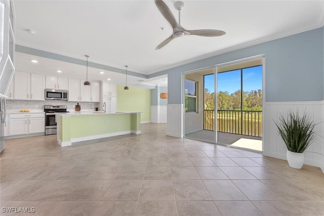 6058 National Blvd Unit 327, Ave Maria, FL 34142 - unfurnished living room featuring recessed lighting, light tile patterned flooring, wainscoting, crown molding, and ceiling fan