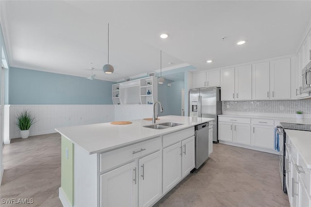 6058 National Blvd Unit 327, Ave Maria, FL 34142 - kitchen featuring a sink, white cabinets, a wainscoted wall, and stainless steel appliances