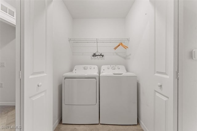6058 National Blvd Unit 327, Ave Maria, FL 34142 - clothes washing area featuring washer and dryer, laundry area, baseboards, and visible vents