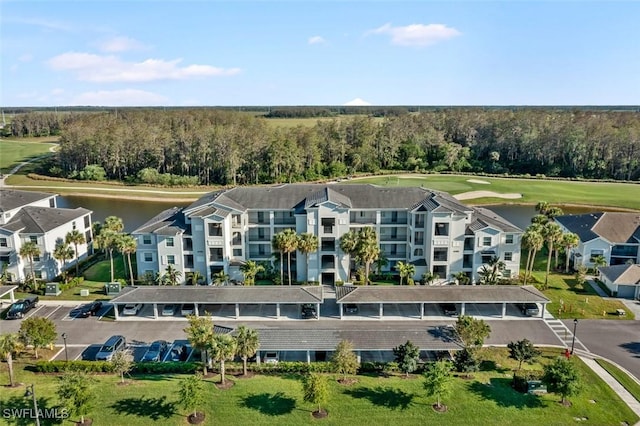 6058 National Blvd Unit 327, Ave Maria, FL 34142 - drone / aerial view with golf course view, a view of trees, and a water view